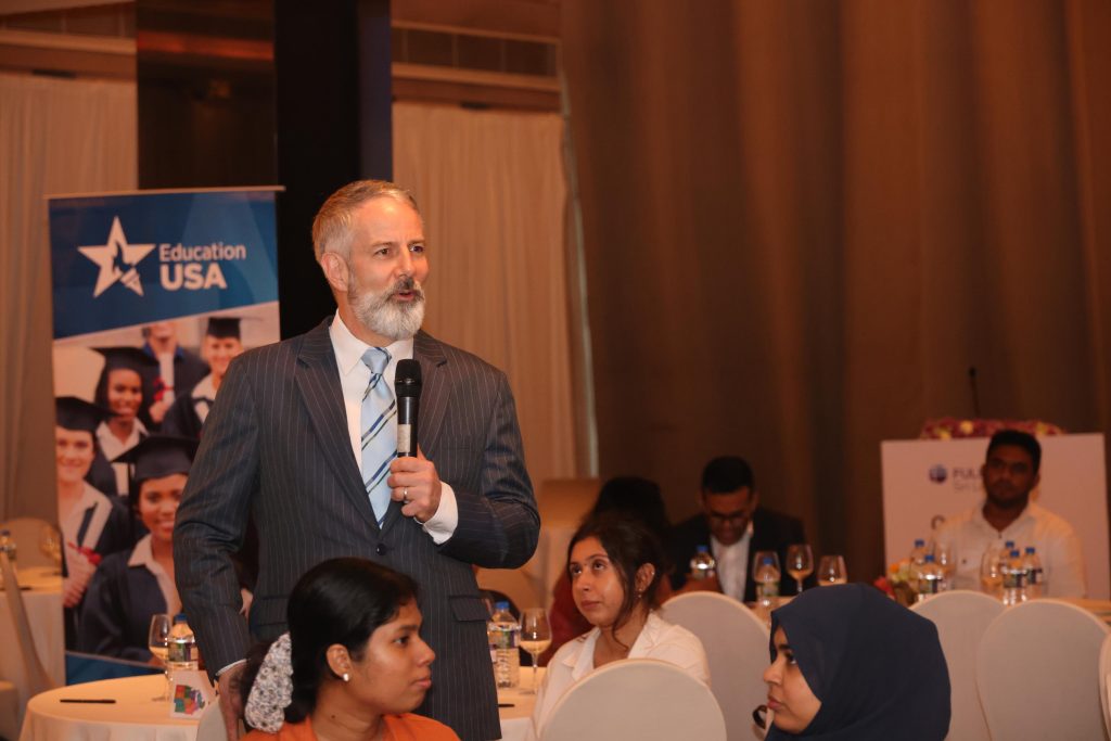 Chargé d'Affaires Douglas Sonnek engaging with students during the pre-departure orientation